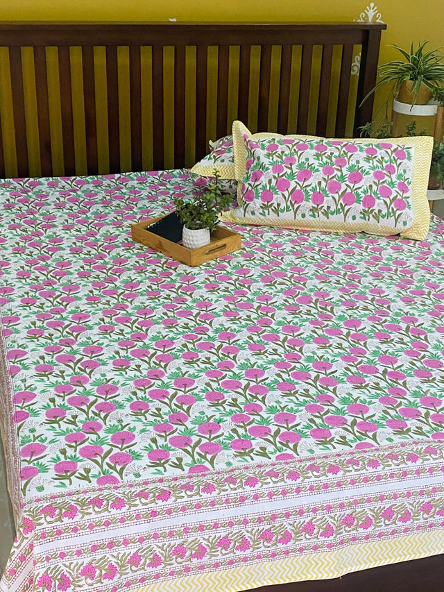 Pink floral hand block printed bedsheet on white base