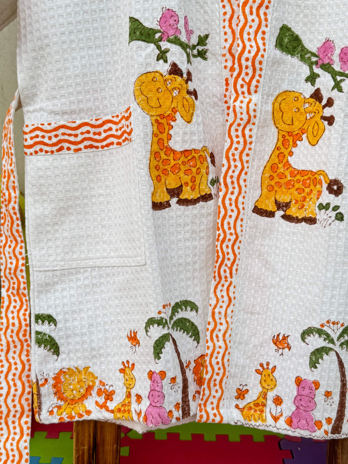 Close-up of cotton waffle fabric with giraffe print.
