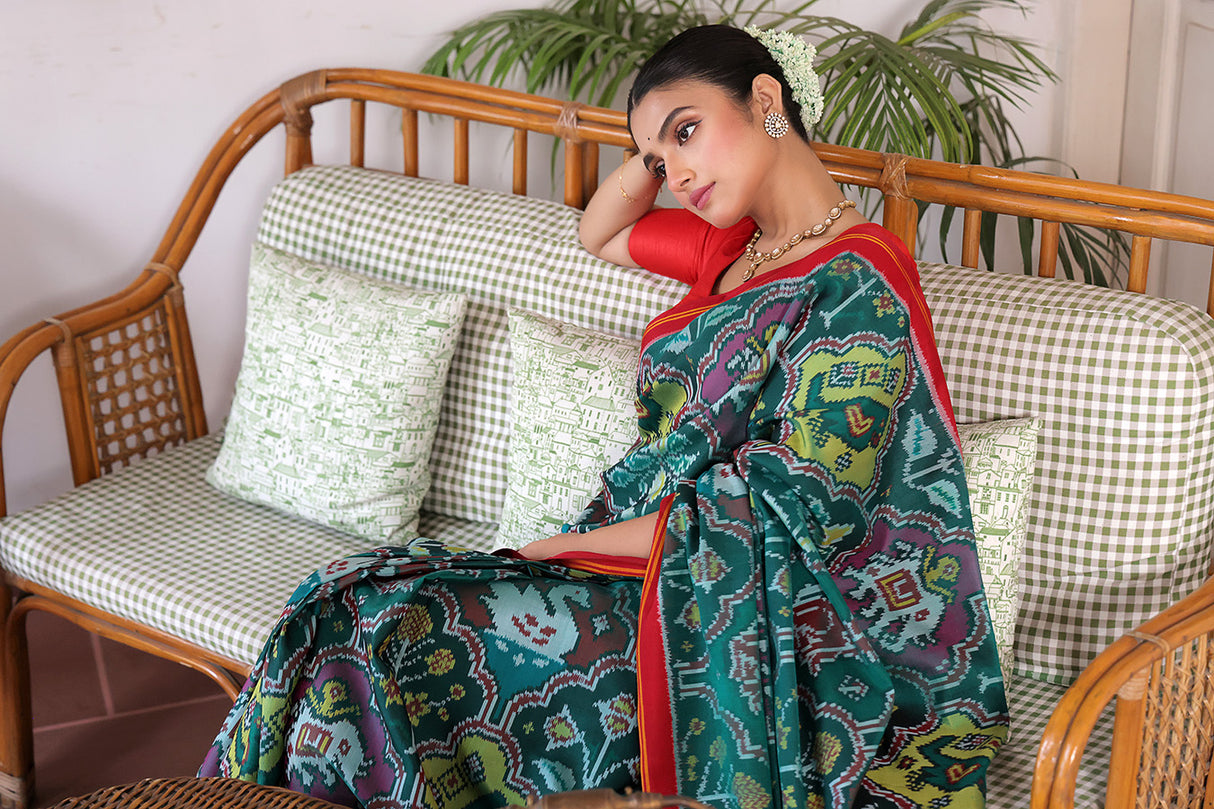 Exclusive Handloom Green and Red Mulberry Silk Ikat Patola Saree with Floral and Animal Motifs