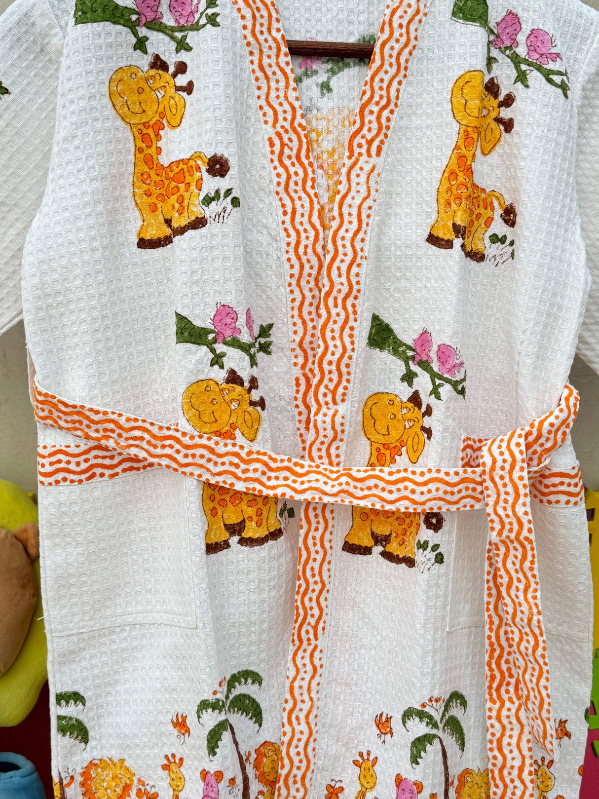 Giggly Giraffe kids bathrobe in a styled bathroom.
