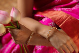 lady wearing a kanjivaram bandhani saree with beautiful 02.5 silver kadas with moissanite polki