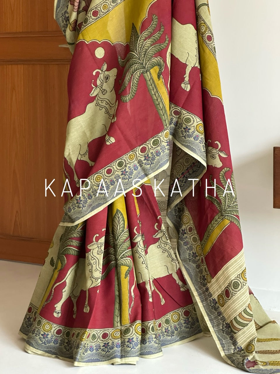 Shop handpainted Chettinad cotton Kalamkari saree featuring traditional Nandi and botanical artwork. Breathable, handloom luxury online at Kapaas Katha.