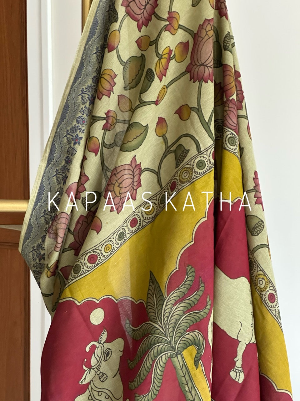 Shop handpainted Chettinad cotton Kalamkari saree featuring traditional Nandi and botanical artwork. Breathable, handloom luxury online at Kapaas Katha.