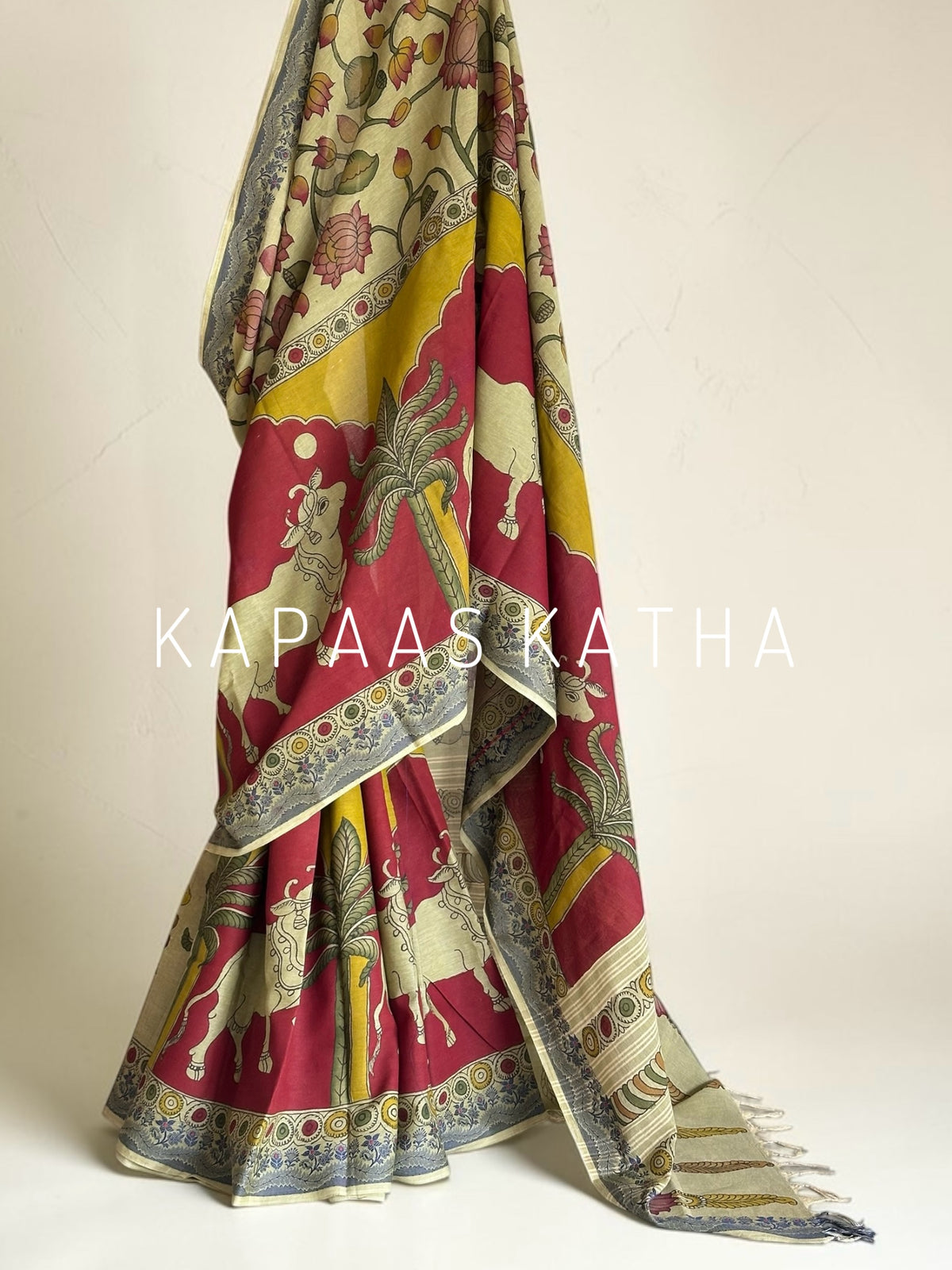 Shop handpainted Chettinad cotton Kalamkari saree featuring traditional Nandi and botanical artwork. Breathable, handloom luxury online at Kapaas Katha.