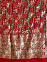 Buy pure Banarasi georgette Bandhani saree in vermilion red with gold zari elephant motifs & rich woven pallu. Authentic handloom luxury online at Kapaas Katha.