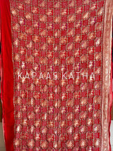 Buy pure Banarasi georgette Bandhani saree in vermilion red with gold zari elephant motifs & rich woven pallu. Authentic handloom luxury online at Kapaas Katha.