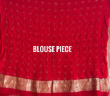 Buy pure Banarasi georgette Bandhani saree in vermilion red with gold zari elephant motifs & rich woven pallu. Authentic handloom luxury online at Kapaas Katha.