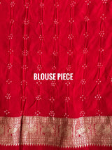 Buy pure Banarasi georgette Bandhani saree in vermilion red with gold zari elephant motifs & rich woven pallu. Authentic handloom luxury online at Kapaas Katha.