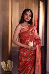 Buy pure Banarasi georgette Bandhani saree in vermilion red with gold zari elephant motifs & rich woven pallu. Authentic handloom luxury online at Kapaas Katha.