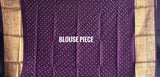 Buy pure Vasundhara silk Bandhani saree in plum purple with gold zari checks & rich pallu. Authentic handwoven luxury online at Kapaas Katha.
