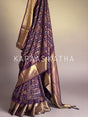 Buy pure Vasundhara silk Bandhani saree in plum purple with gold zari checks & rich pallu. Authentic handwoven luxury online at Kapaas Katha.