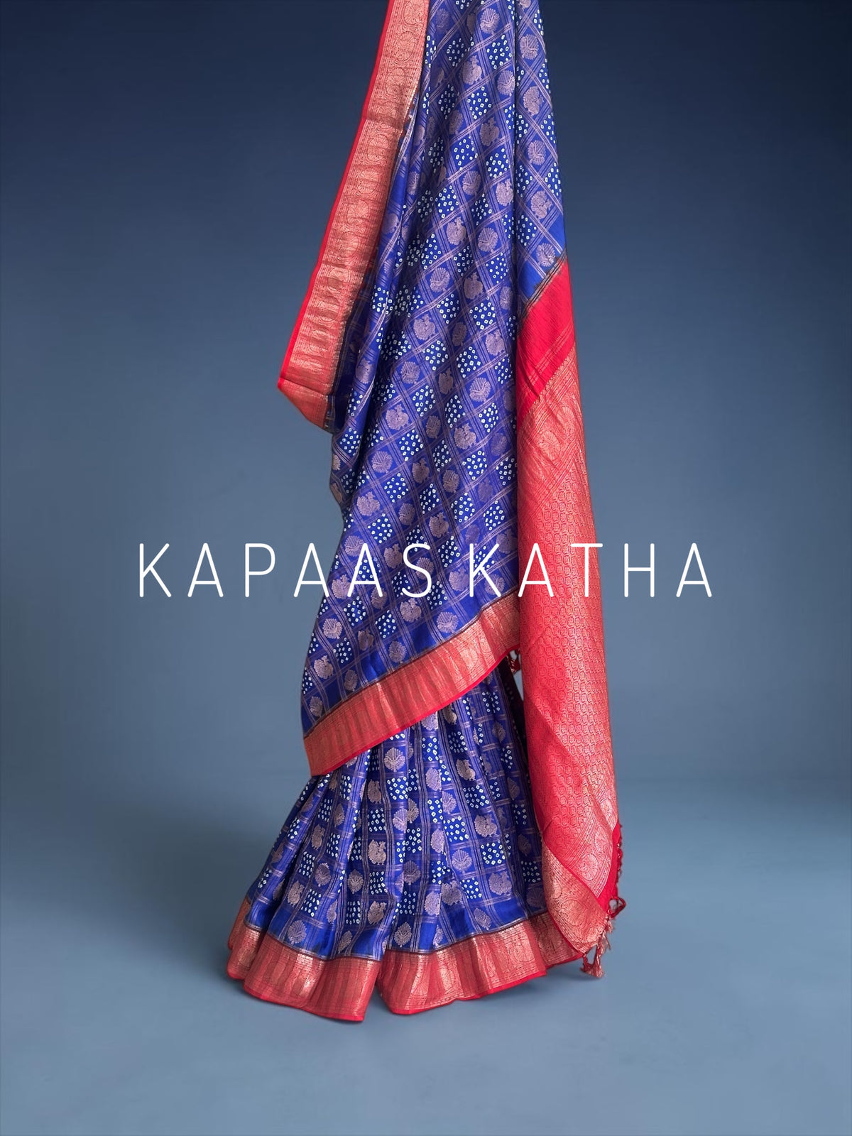Buy pure Vasundhara silk Bandhani saree in royal blue with contrast crimson red zari border & rich pallu. Authentic handwoven luxury online at Kapaas Katha.