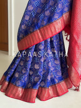 Buy pure Vasundhara silk Bandhani saree in royal blue with contrast crimson red zari border & rich pallu. Authentic handwoven luxury online at Kapaas Katha.