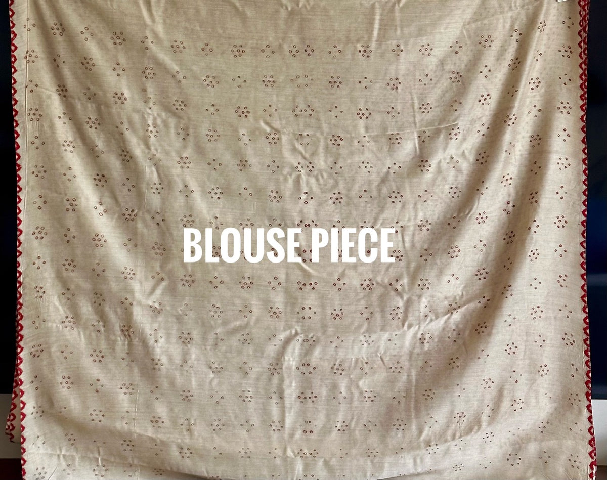 Buy pure Munga silk Bandhani saree in linen beige with soft red ghangura border. Lightweight handloom elegance for daytime festivities at Kapaas Katha.